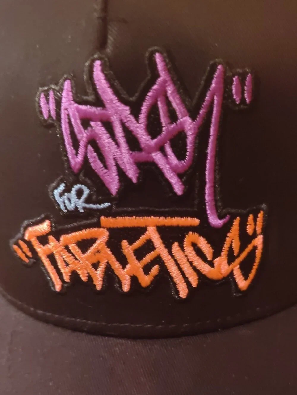 Fabletics Black Trucker Hat with Purple and Orange Embroidered Logo